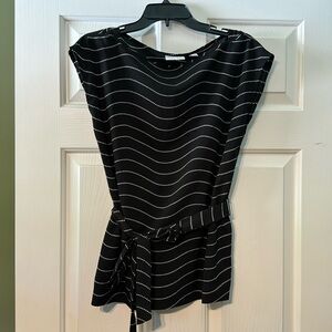 Black and white sleeveless top with belt to tie around the mid section